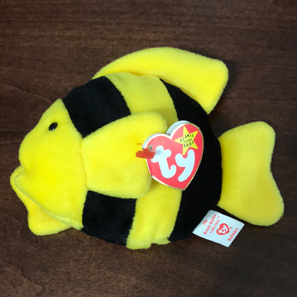 Ty Beanie Baby with a red heart hang tag on the ear and a fabric tush tag sewn into the seam, the two tags used to date it